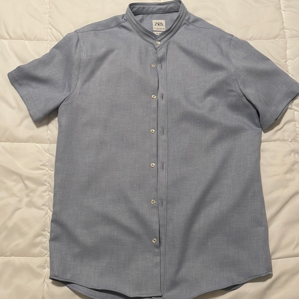 Light blue, no collar, button down.
